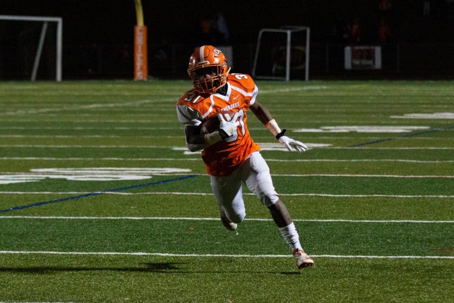 Dhante Johnson runs the ball down field against Kingsway