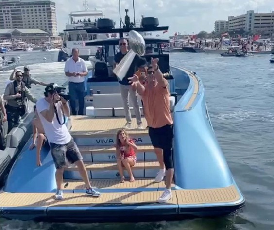 Tom Brady throwing the Lombardi Trophy during the Super Bowl boat parade in Tampa on February 10, 2021