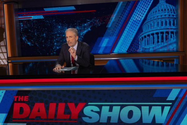 Jon Stewart at the desk of The Daily Show.