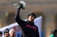 Jalen Hurts holding up the Lombardi Trophy after the Eagles Super Bowl win